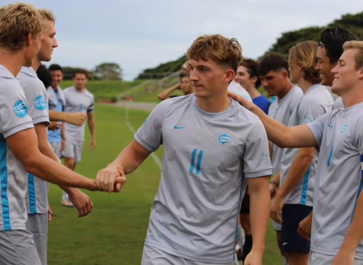 Jude Boyd in Hawaii Pacific Sharks #11 grey kit on Senior Day, congratulated by teammates